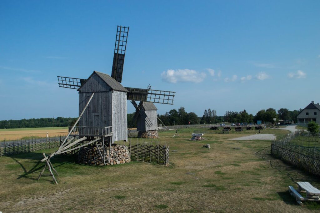 Historic wooden windmills in rural Saaremaa, showcasing European rustic architecture.